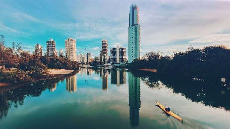yellow kayak on river near city buildings during daytime