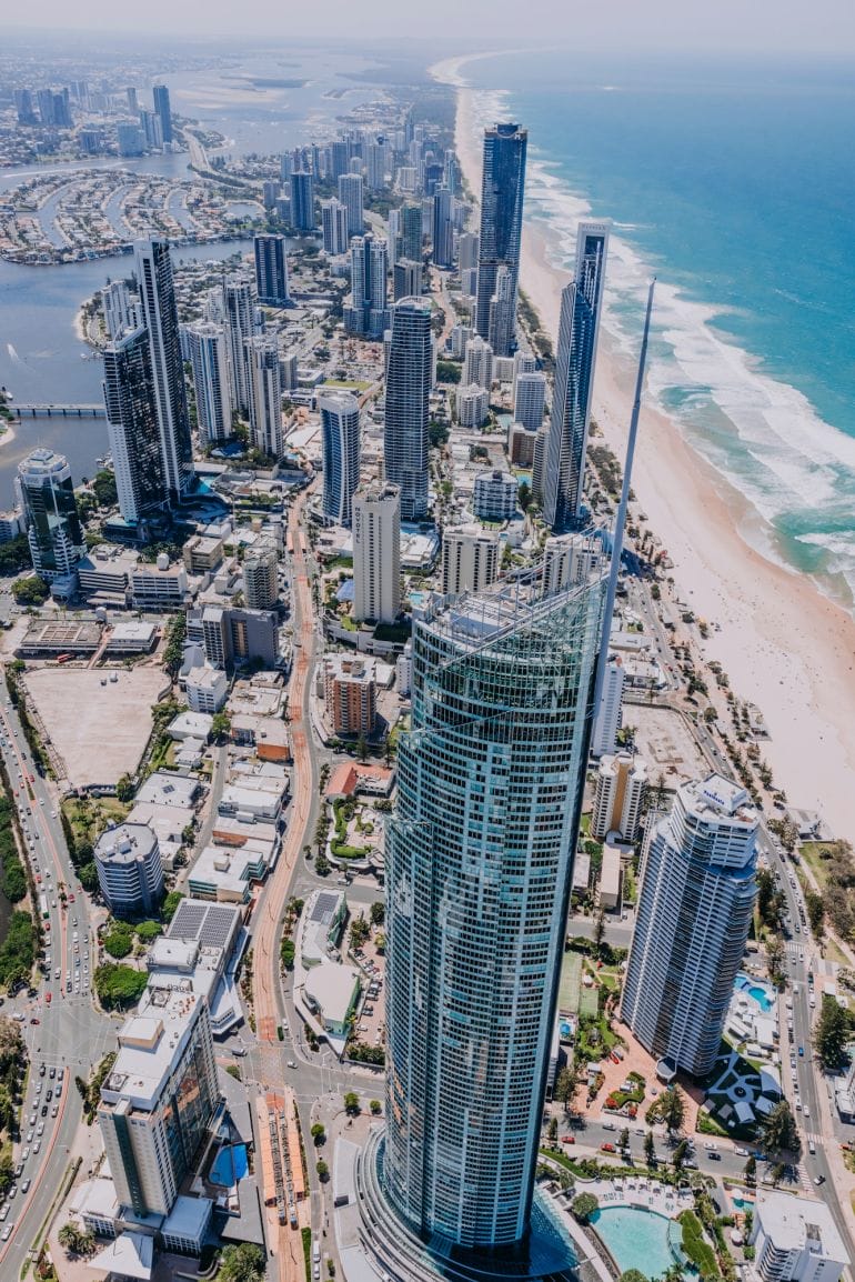 an aerial view of a city with a beach in the background