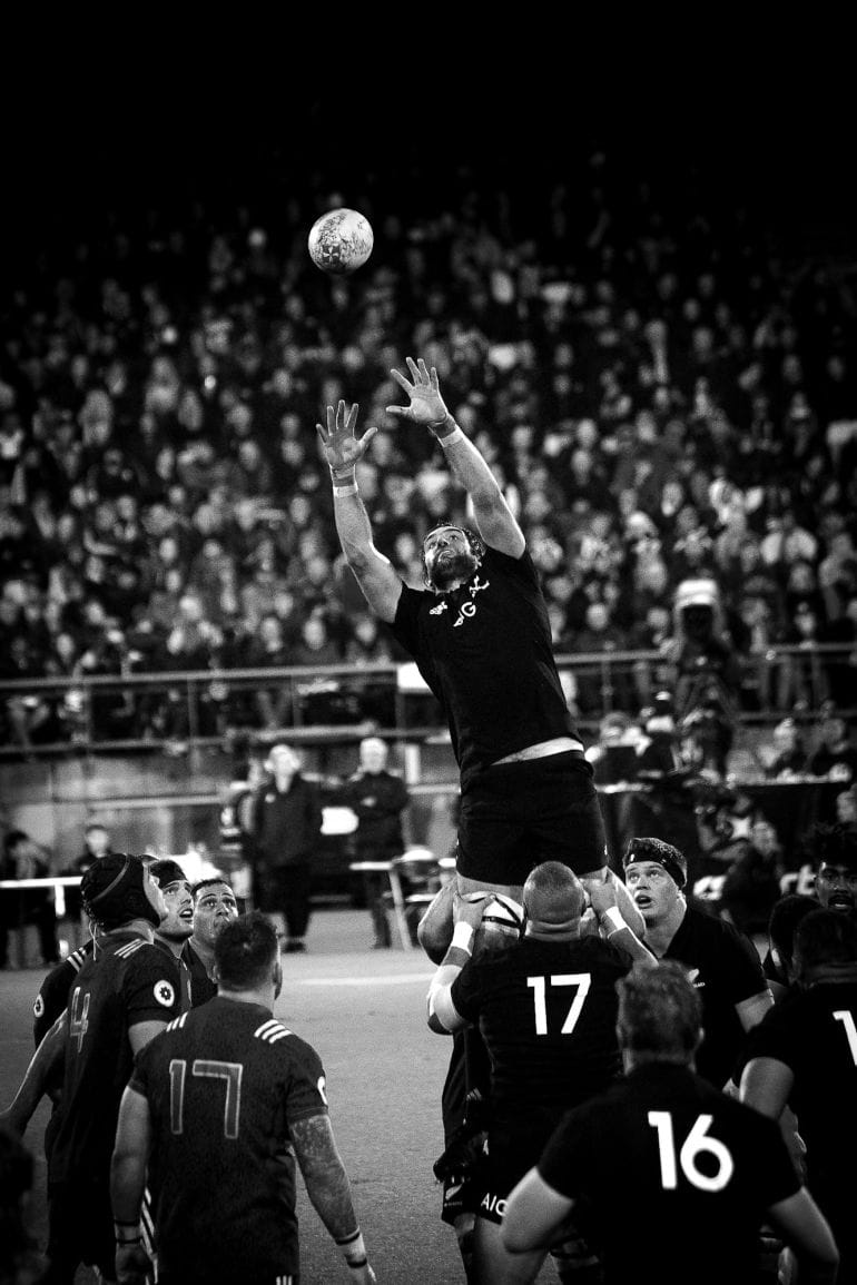 grayscale photo of player catching ball