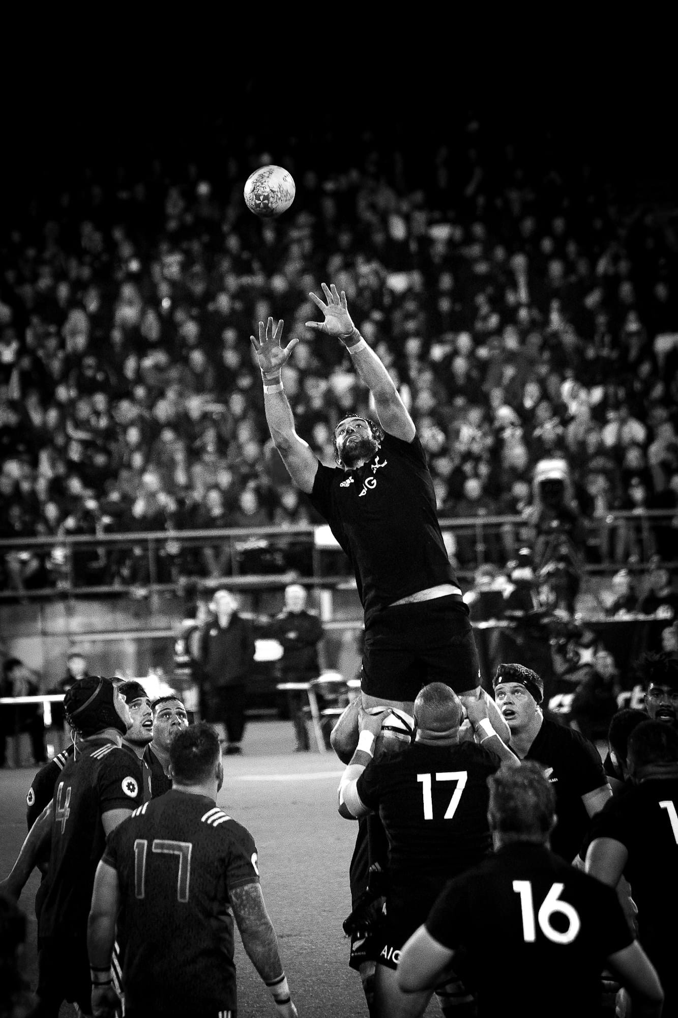 grayscale photo of player catching ball