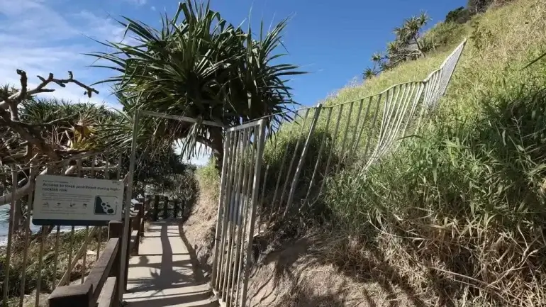 Burleigh Oceanview Track is closed after a rock fall, with QPWS warning people to stay out due to safety risks.