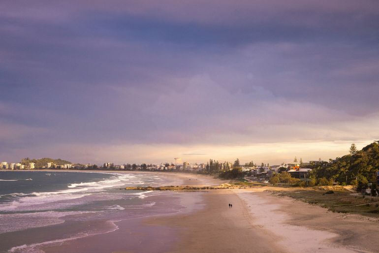 a beach with a city in the background