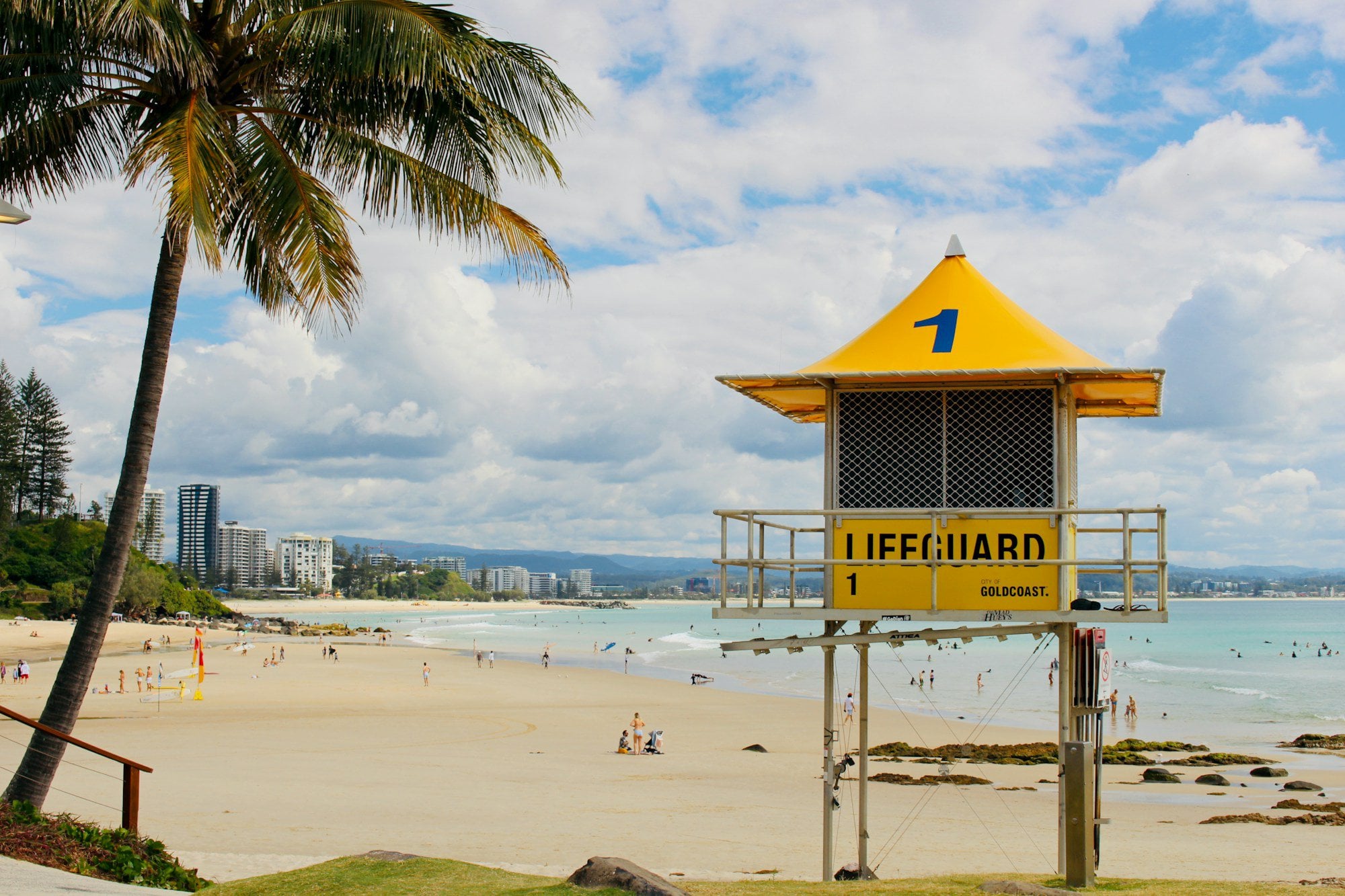 yellow and white lifeguard tower on beach during daytime