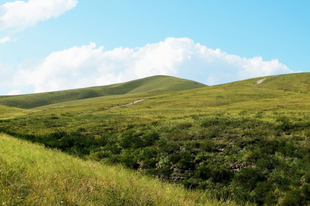 Stone walls and green grassy areas with rolling hills
